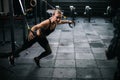 Sporty young woman with perfect muscular body working out on simulator during sport training at gym Royalty Free Stock Photo