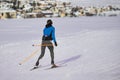 Sporty young woman practicing cross country skiing