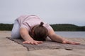 Sporty young woman practicing yoga, sitting in Child exercise, Balasana pose Royalty Free Stock Photo