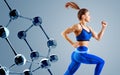 Sporty young woman runing and jumping near glass molecules.