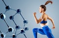 Sporty young woman runing and jumping near molecules chain.