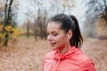 Sporty young woman running in the park and listening to music. Sport lifestyle. Royalty Free Stock Photo