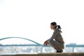 Sporty young woman sitting outdoors