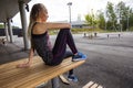 Sporty Young Woman Sitting On Wooden Bench At Park Royalty Free Stock Photo