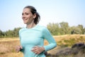 Sporty young woman in sportswear jogging, running and training outdoors on a sunny day in summer Royalty Free Stock Photo