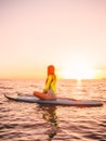 Stand up paddle boarding on a sea with warm sunset colors. Relaxing on ocean Royalty Free Stock Photo