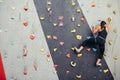 Sporty young woman training in a colorful climbing gym. Royalty Free Stock Photo