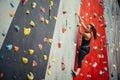 Sporty young woman training in a colorful climbing gym. Royalty Free Stock Photo