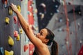 Sporty young woman training in a colorful climbing gym. Royalty Free Stock Photo