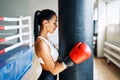 Sporty young woman wearing boxing gloves posing in gym Royalty Free Stock Photo