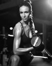 Sporty young woman working out with dumbbells weight in Gym. Diet and weight loss concept Royalty Free Stock Photo
