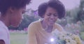 Spot of light against african american mother and daughter gardening together in the garden Royalty Free Stock Photo