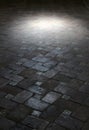 Spot light on an ancient floor of tiles