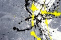 A spot of white and black and yellow spilled paint on a concrete textured surface Royalty Free Stock Photo
