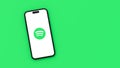 Spotify Logo on Mobile Phone Screen on Green Background with Copy Space