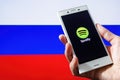Spotify music service on screen of mobile phone against background of Russian flag: Ufa, Russia - 13 December, 2019 Royalty Free Stock Photo