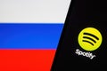 Spotify sign on screen of mobile phone against background of Russian flag: Ufa, Russia - December 13, 2019 Royalty Free Stock Photo