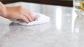 Spotless Cleanliness: Hand Wiping Marble Countertop. Generative ai