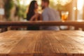 spotless wood table, blurred couple enjoying drinks behind