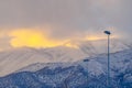Spotlight against snowy Utah mountain at sunset