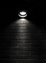 Spotlight on a black brick wall