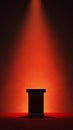 Spotlight on Empty Podium in Dramatic Red and Black Background Royalty Free Stock Photo