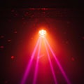 A spotlight hanging from the ceiling emits a strong red and pink light, creating a Royalty Free Stock Photo