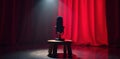 Spotlight illuminates mic on stool, crimson curtain, sound, performance space Royalty Free Stock Photo