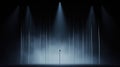 A spotlight illuminates a stage with a microphone stand in the center. Royalty Free Stock Photo
