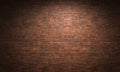 Spotlight illuminating brick wall background texture in dark room Royalty Free Stock Photo