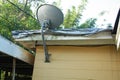 Satellite mounted-roof-home mounted on the roof of a home that is covered with a FEMA type tarp