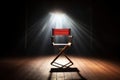 spotlight shining on an empty directors chair Royalty Free Stock Photo