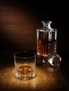 A spotlight on a single crystal glass of scotch whisky with a de