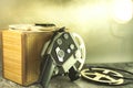 White spools of old film and a camera in the spotlight. Royalty Free Stock Photo