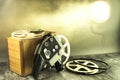 White spools of old film and a camera in the spotlight. Royalty Free Stock Photo