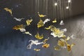 Spotlights illuminated interior chandelier made of golden and transparent Swarovski crystals shaped like a leaves