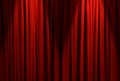 Spotlights illuminating closed red stage curtains. Start of performance Royalty Free Stock Photo