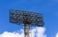 Spotlights at the stadium in the afternoon on a background of blue summer sky Royalty Free Stock Photo