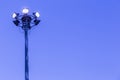 Spotlights tower high voltage in sport stadium on blue sky background Royalty Free Stock Photo