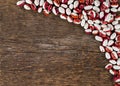 Spotted beans on a background of rough wooden texture Royalty Free Stock Photo
