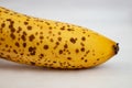 Spotted ripe banana, on white background, crop close up, abstract  texture Royalty Free Stock Photo