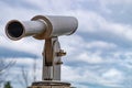 The image shows a spotting scope with a white sky in the background. Royalty Free Stock Photo