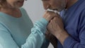 Spouse kissing hands of his beloved wife saying words of love, embarrassment