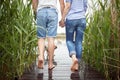 Spouses barefoot enjoy an after rain weather on the dock Royalty Free Stock Photo