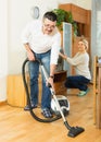 Spouses dusting and hoovering Royalty Free Stock Photo