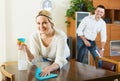 Spouses dusting and hoovering Royalty Free Stock Photo