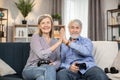 Spouses giving high five after gaming session at home