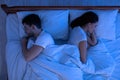 Spouses Sleeping Lying Back-To-Back In Bed In Bedroom, Above View