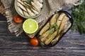 Sprats in a can, fresh gastronomy gourmet nutritious delicious dill lime lunch on wooden background