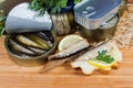 Sprats in open tin can, open sandwiches against other cans